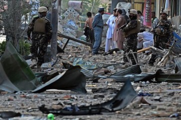 Afghan security forces and residents  inspect the site of a powerful truck bomb explosion in Kabul on August 7, 2015. A powerful truck bomb killed at least seven people and wounded more than 100 others, officials said, the first major attack in the Afghan capital since the announcement of Taliban leader Mullah Omar's death. AFP PHOTO / Wakil Kohsar        (Photo credit should read WAKIL KOHSAR/AFP/Getty Images)