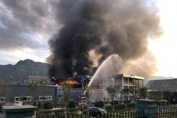 Rescue workers try to put out a fire after an explosion at a chemical plant inside an industrial park in Yibin, Sichuan province, China July 12, 2018. Picture taken July 12, 2018.  China Daily via REUTERS  ATTENTION EDITORS - THIS IMAGE WAS PROVIDED BY A THIRD PARTY. CHINA OUT.